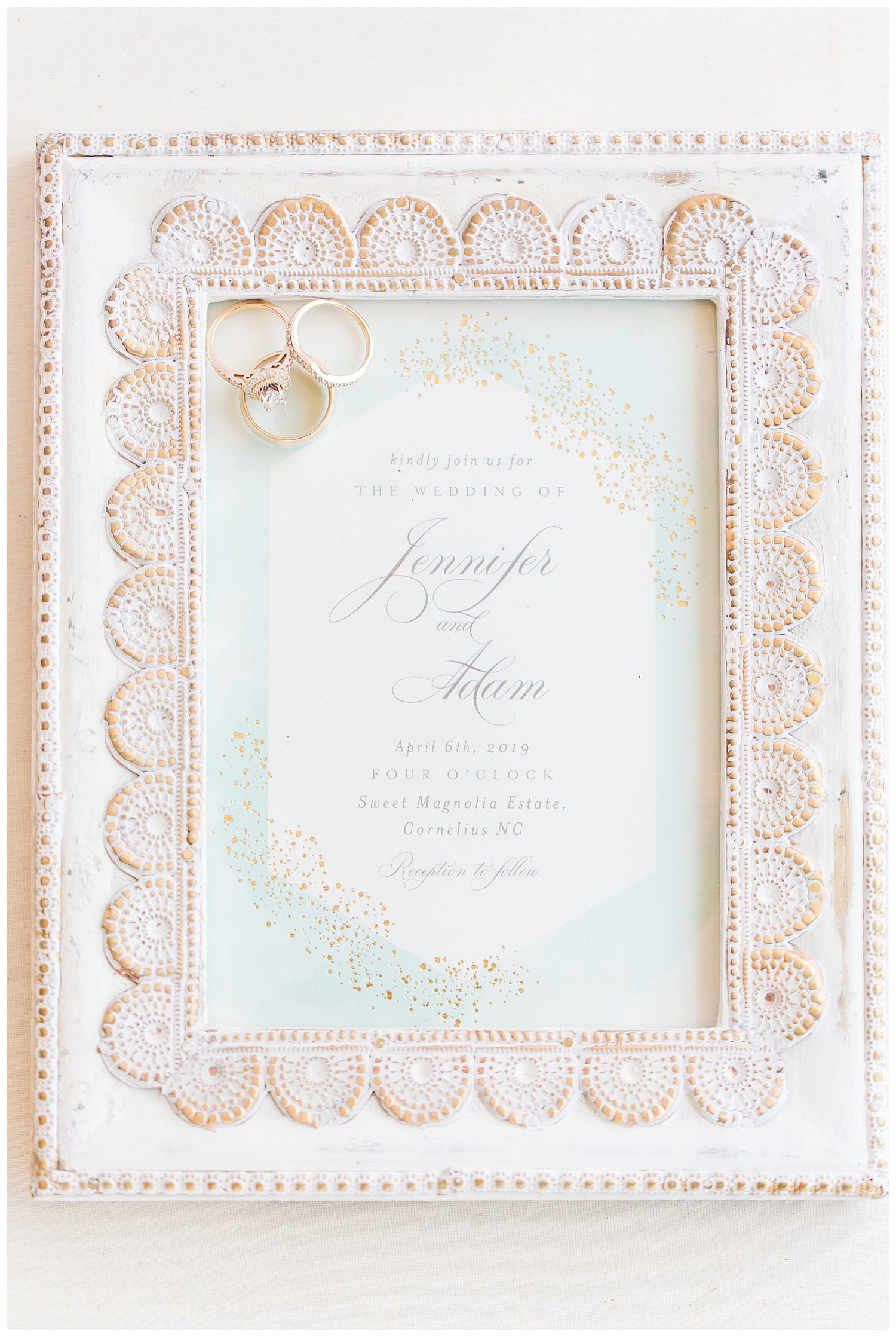 invitation in a frame with wedding rings at a Southern Elegant Wedding at Sweet Magnolia Estate in Charlotte, NC