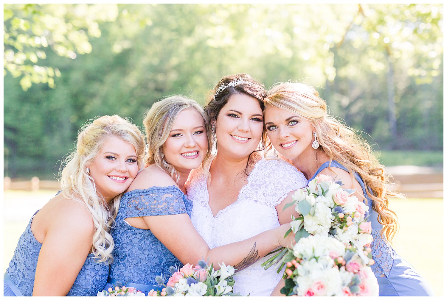 Wedding party with dusty blue bridesmaids dresses and groomsmen in jeans rustic wedding in Charlotte NC