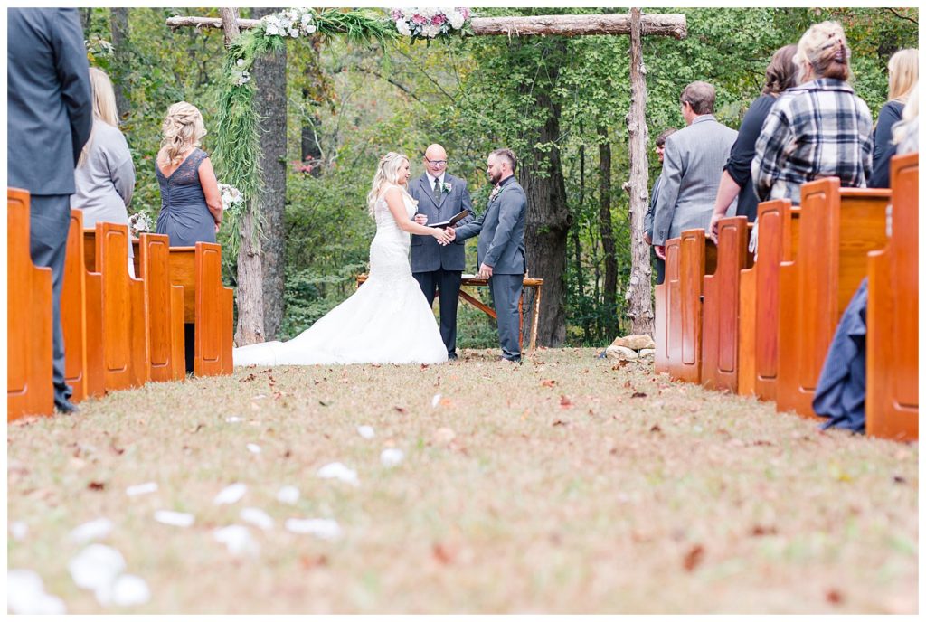 Bride and groom at the alter at the Shed at Quiet Hollow in Maiden, NC by Charlotte wedding photographer, Jacqueline Jones