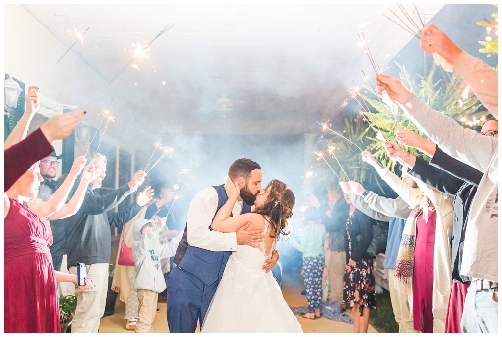 Kissing and sparklers in Morganton, NC at Double C’s Acres by Charlotte wedding photographer, Jacqueline Jones