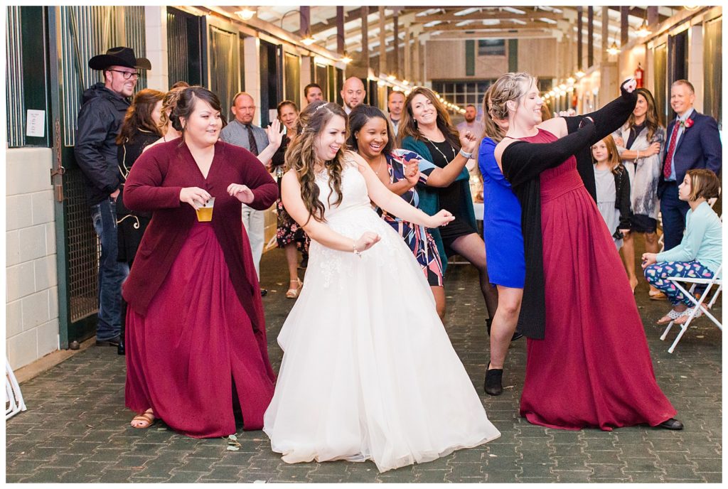 Bride and bridesmaids dancing in Morganton, NC at Double C’s Acres by Charlotte wedding photographer, Jacqueline Jones