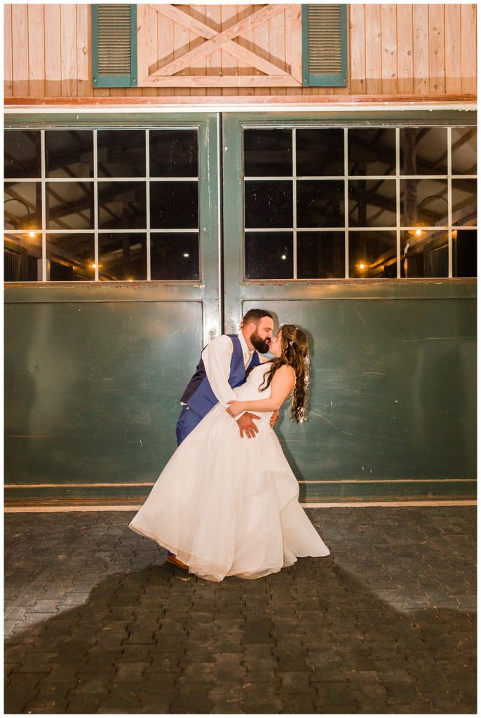 Bride and groom kissing in Morganton, NC at Double C’s Acres by Charlotte wedding photographer, Jacqueline Jones