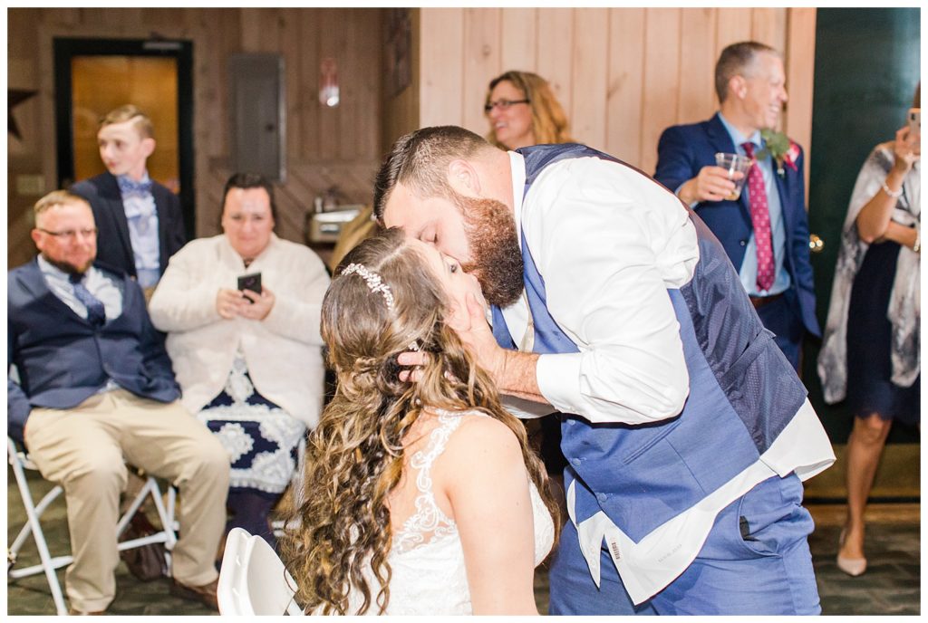 Bride and groom kissing in Morganton, NC at Double C’s Acres by Charlotte wedding photographer, Jacqueline Jones