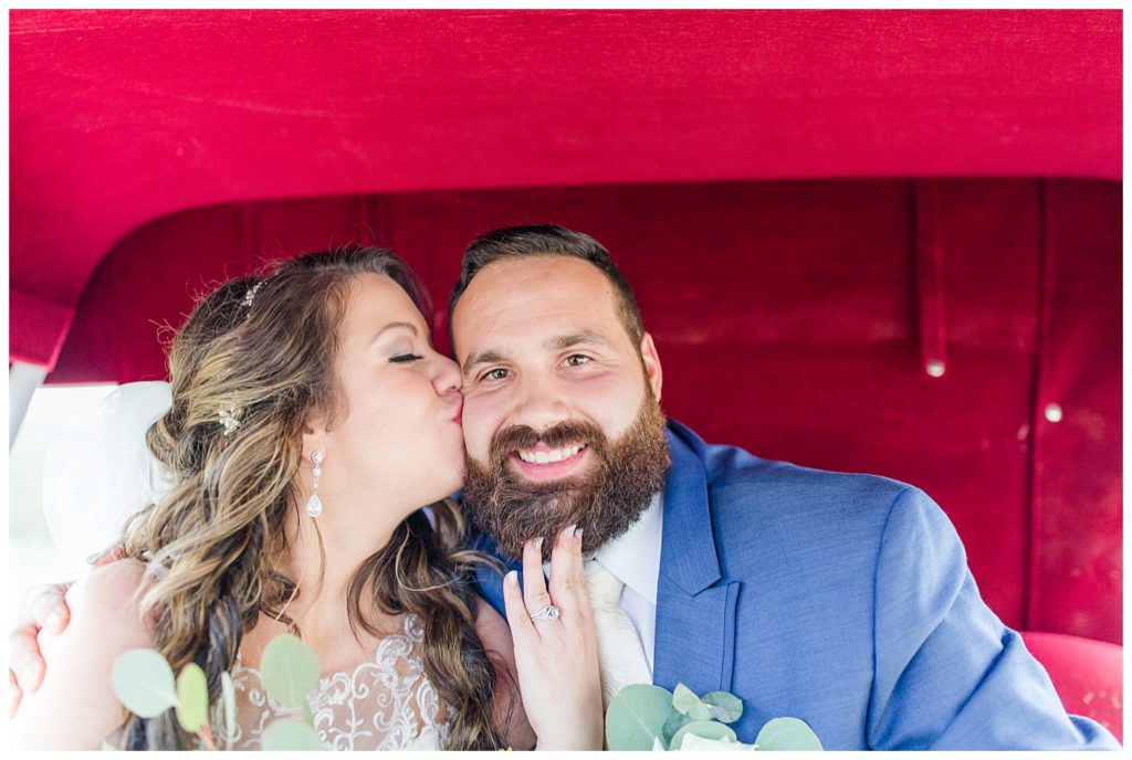 Married couple in carriage in Morganton, NC at Double C’s Acres by Charlotte wedding photographer, Jacqueline Jones