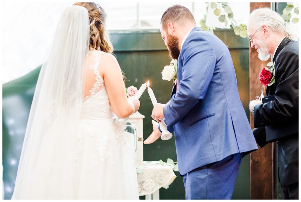 Groom and bride lighting candles in Morganton, NC at Double C’s Acres by Charlotte wedding photographer, Jacqueline Jones