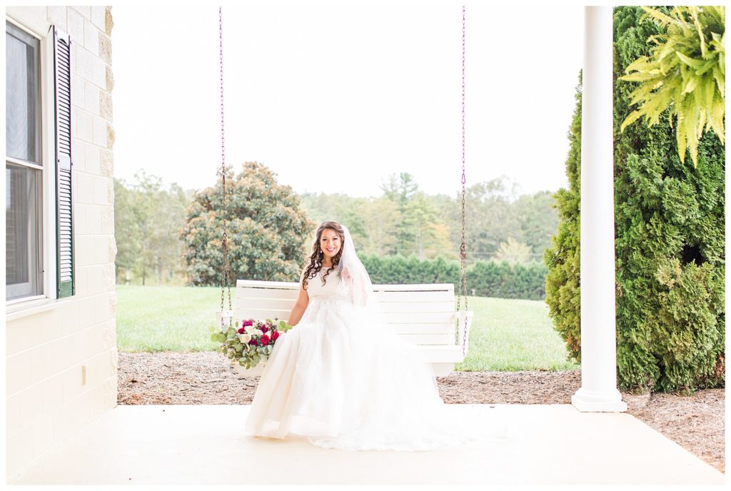 Bride on swing in Morganton, NC at Double C’s Acres by Charlotte wedding photographer, Jacqueline Jones