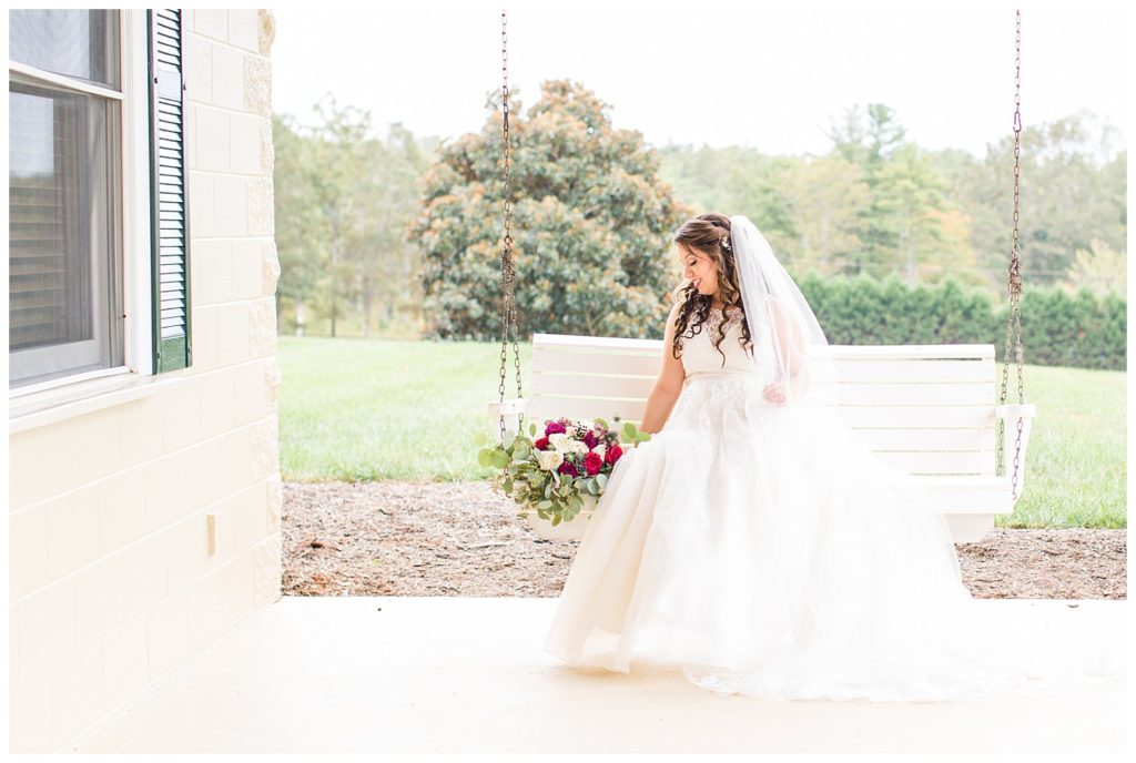 Bride on swing in Morganton, NC at Double C’s Acres by Charlotte wedding photographer, Jacqueline Jones