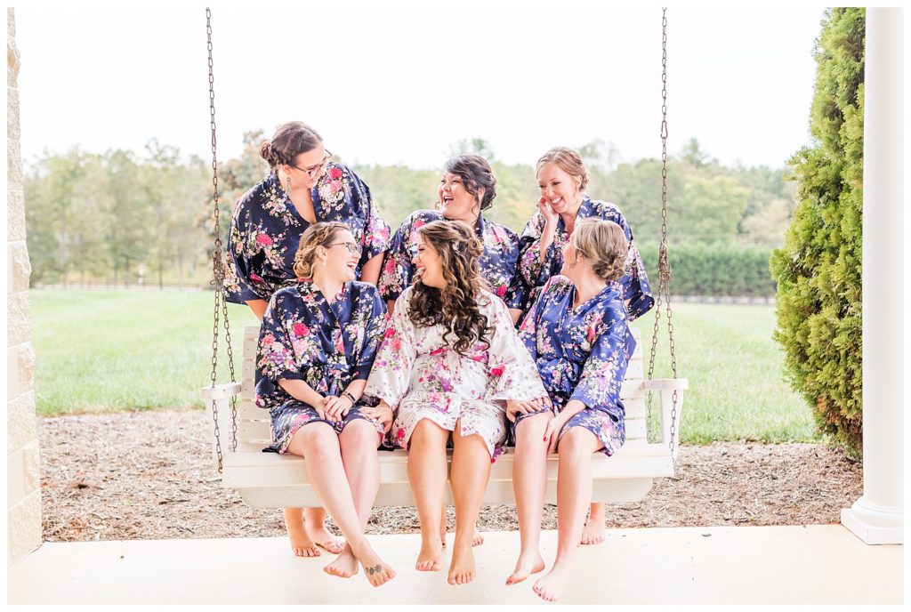 Bride and bridesmaids on swing in Morganton, NC at Double C’s Acres by Charlotte wedding photographer, Jacqueline Jones