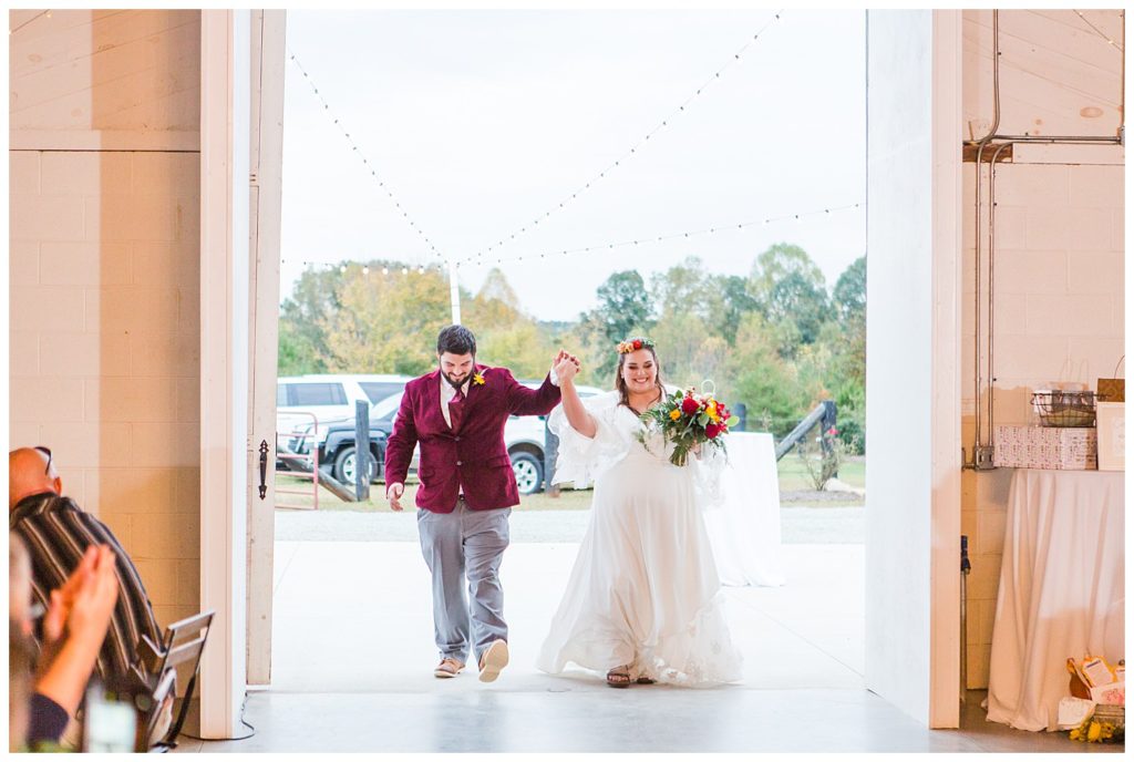 Bride and groom holding hands at Circle M Farm in Lincolnton, NC by Charlotte wedding photographer, Jaqueline Jones