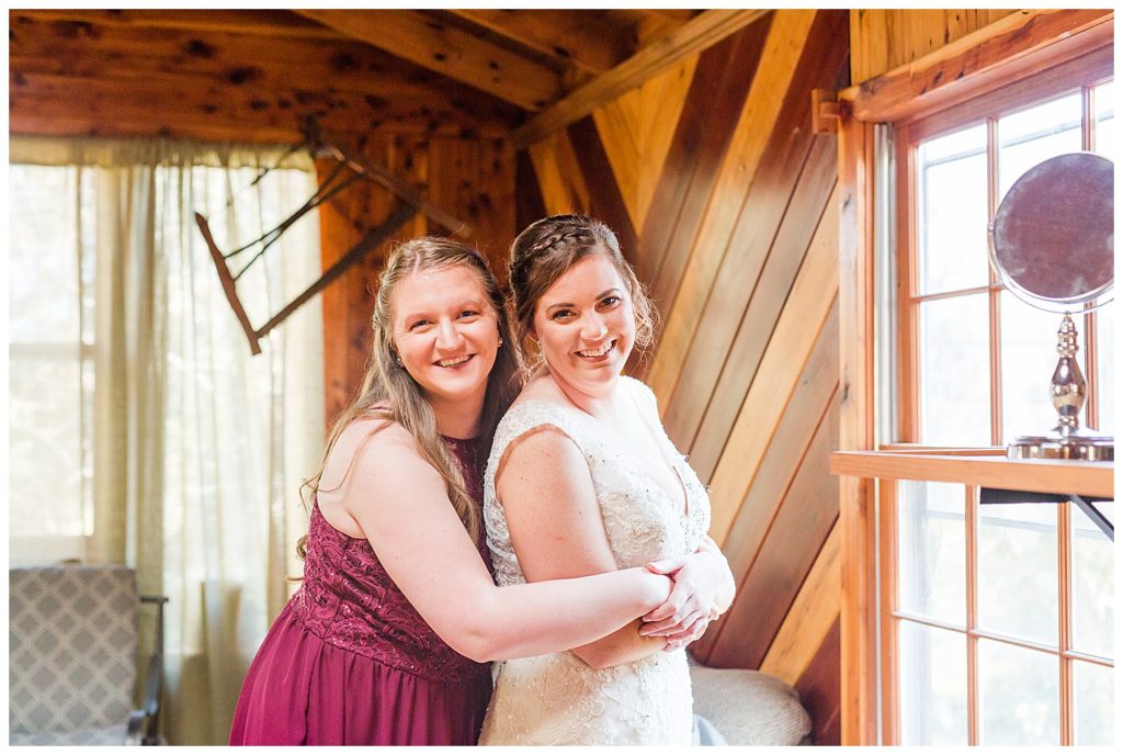 Bridesmaid and bride at wedding at the Barn at Sandcastle in Charlotte, NC by Charlotte wedding photographer, Jacqueline Jones