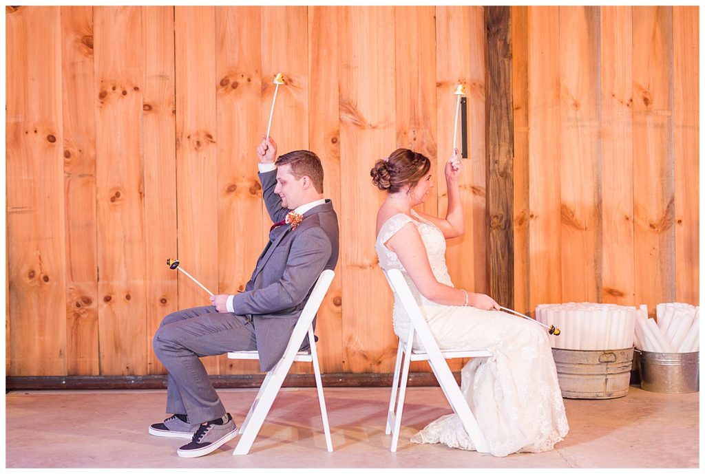 Bride and groom sitting at the Barn at Sandcastle in Charlotte, NC by Charlotte wedding photographer, Jacqueline Jones