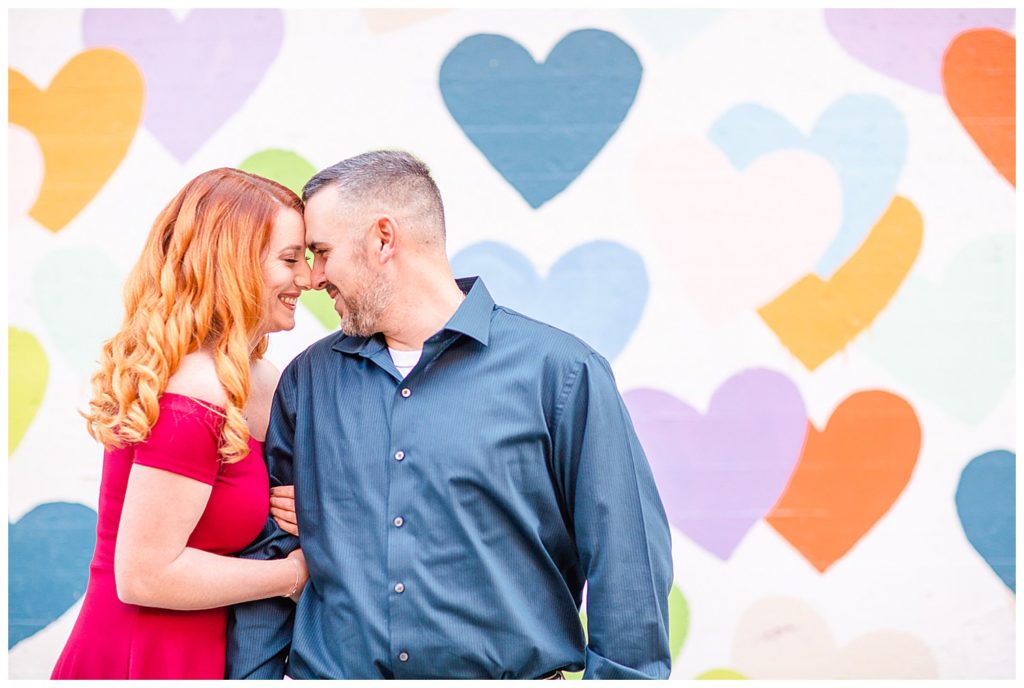 Engaged couple at the Heart Confetti Wall in Charlotte, NC, by Charlotte engagement photographer, Jacqueline Jones