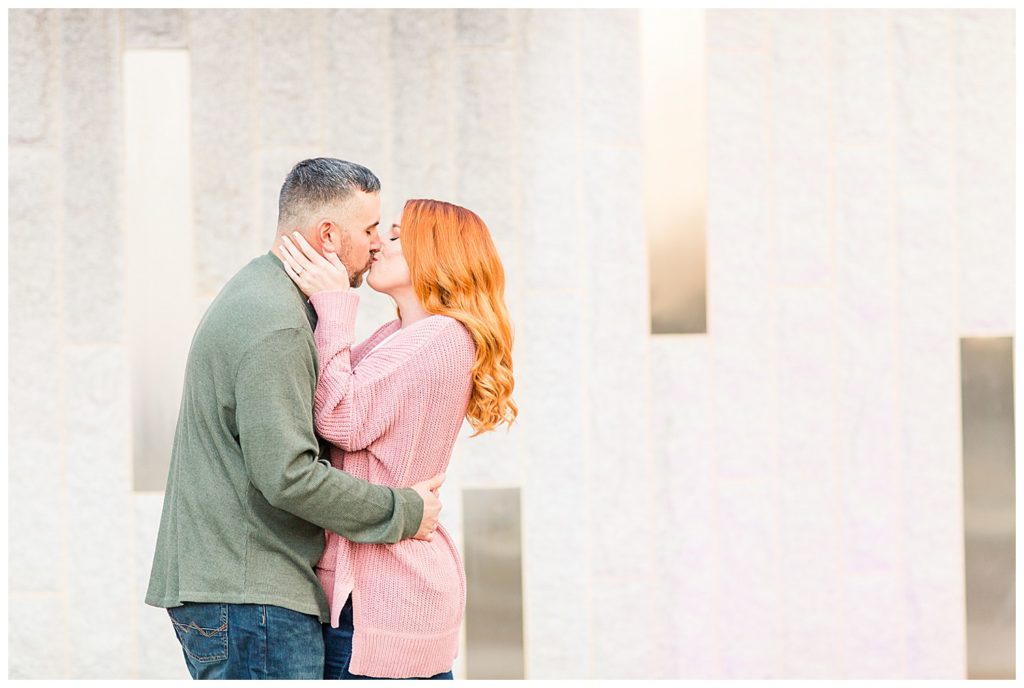 Engaged couple kissing at the Romare Bearden Park in Charlotte, NC, by Charlotte engagement photographer, Jacqueline Jones