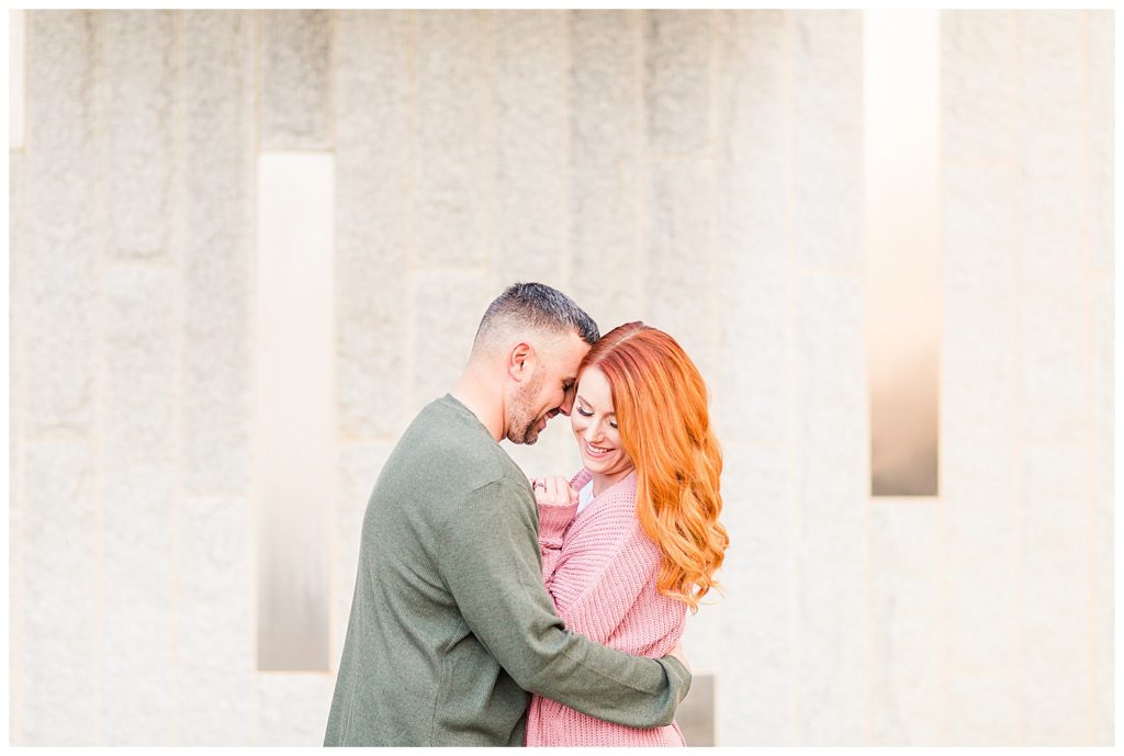 Engaged couple embracing at the Romare Bearden Park in Charlotte, NC, by Charlotte engagement photographer, Jacqueline Jones