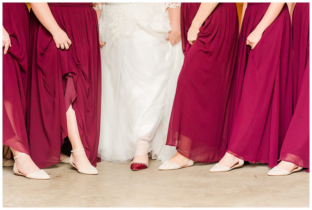 Red and blush bride and bridesmaid’s dresses at the Barn at Sandcastle Farm in Dallas, NC by Charlotte wedding photographer, Jacqueline Jones