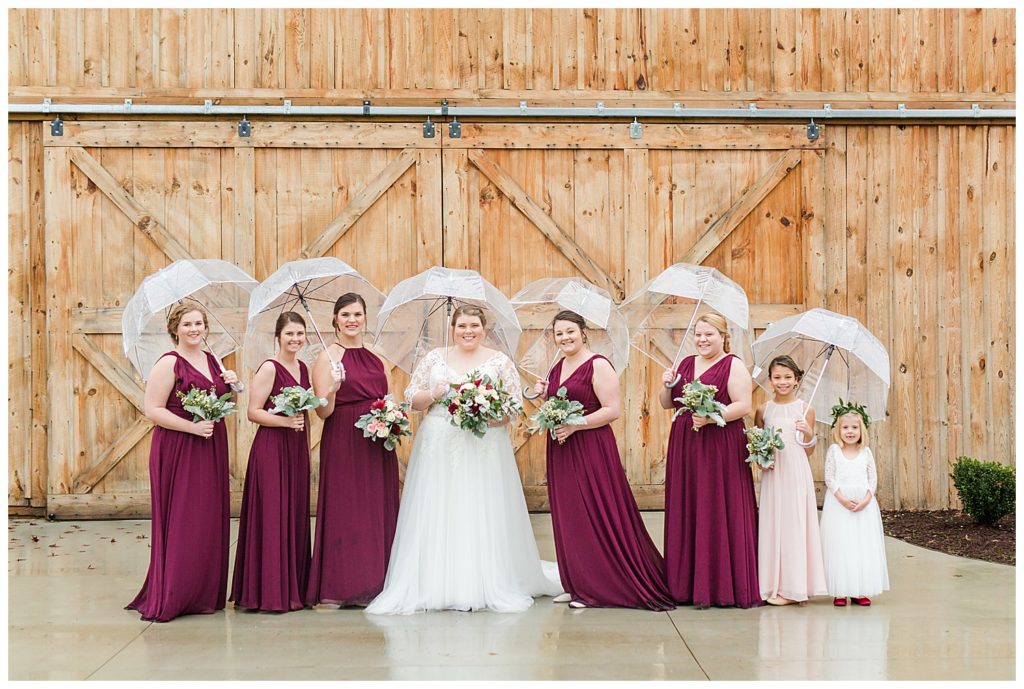 Bridesmaids at the Barn with umbrellas at Sandcastle Farm in Dallas, NC by Charlotte wedding photographer, Jacqueline Jones