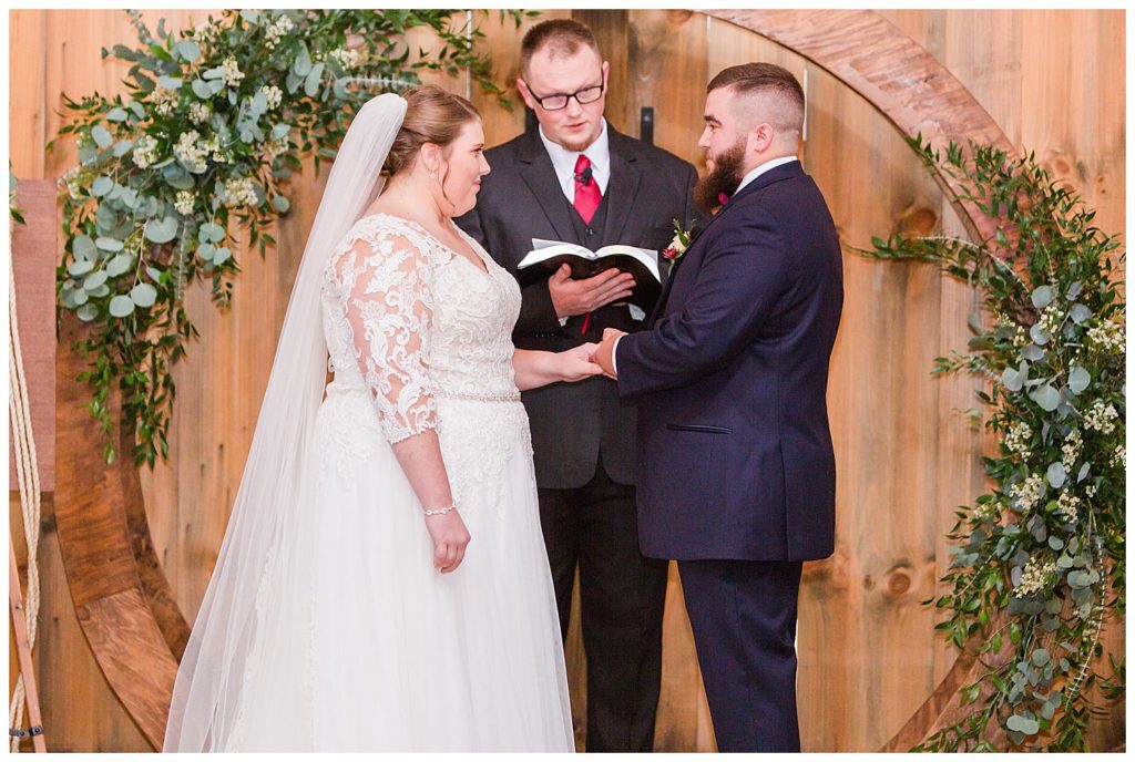 Groom putting on bride’s ring at the Barn at Sandcastle Farm in Dallas, NC by Charlotte wedding photographer, Jacqueline Jones