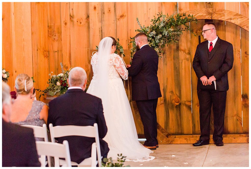 Bride and groom standing at the alter at the Barn at Sandcastle Farm in Dallas, NC by Charlotte wedding photographer, Jacqueline Jones