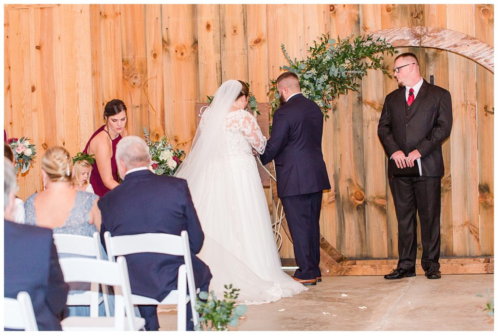 Bride and groom standing at the alter at the Barn at Sandcastle Farm in Dallas, NC by Charlotte wedding photographer, Jacqueline Jones