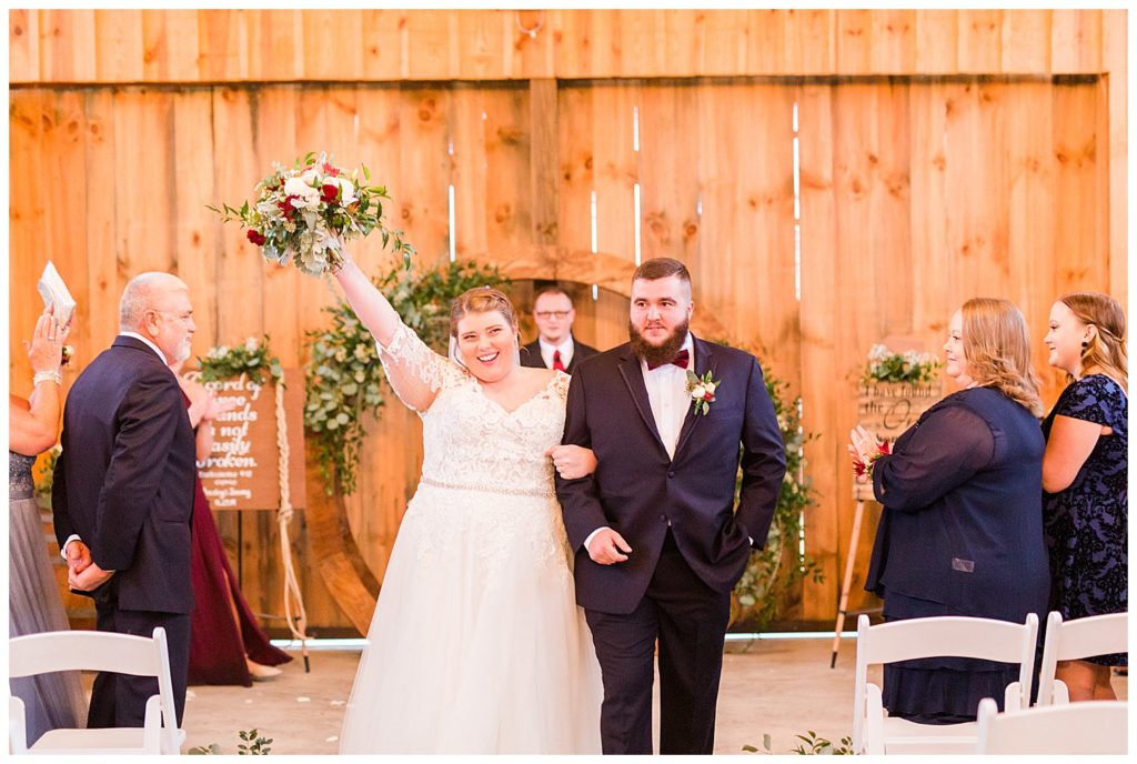 Bride and groom walking down aisle at the Barn at Sandcastle Farm in Dallas, NC by Charlotte wedding photographer, Jacqueline Jones