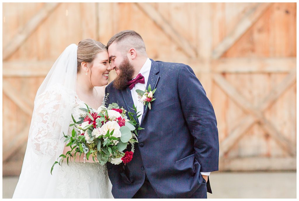 Bride and groom by barn doors at the Barn at Sandcastle Farm in Dallas, NC by Charlotte wedding photographer, Jacqueline Jones