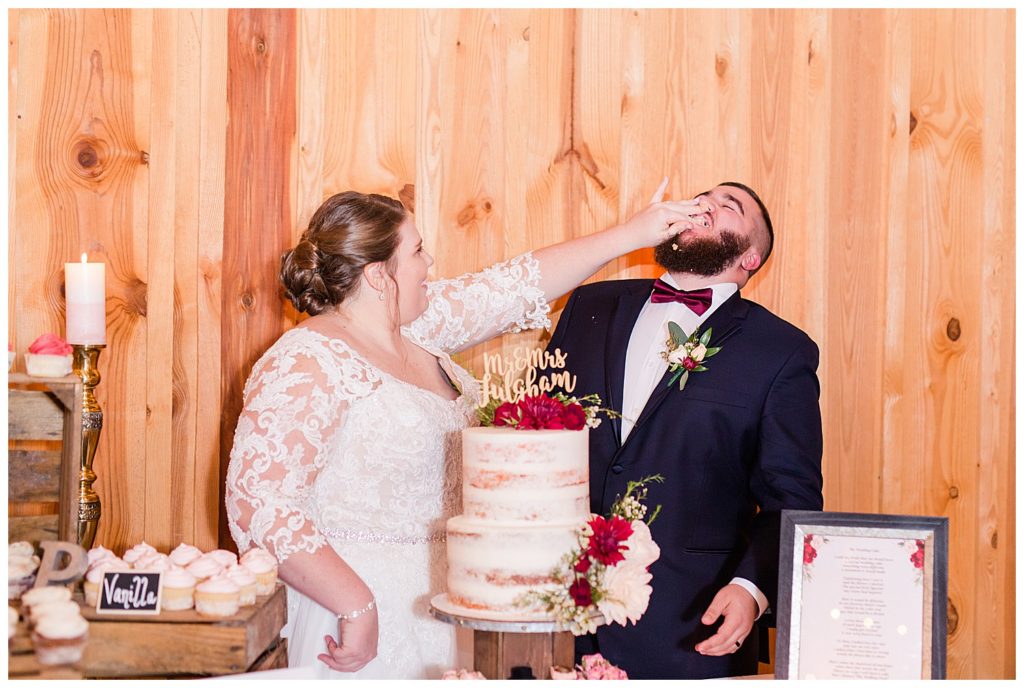 Bride feeding cake to groom at the Barn at Sandcastle Farm in Dallas, NC by Charlotte wedding photographer, Jacqueline Jones