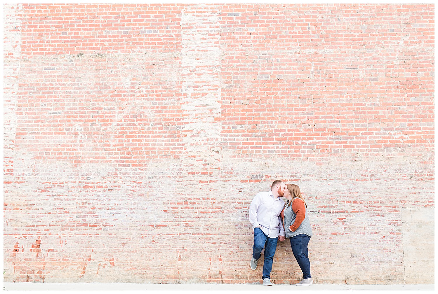 Couple at brick wall in Hickory, NC at Downtown Hickory, by Charlotte engagement photographer, Jacqueline Jones